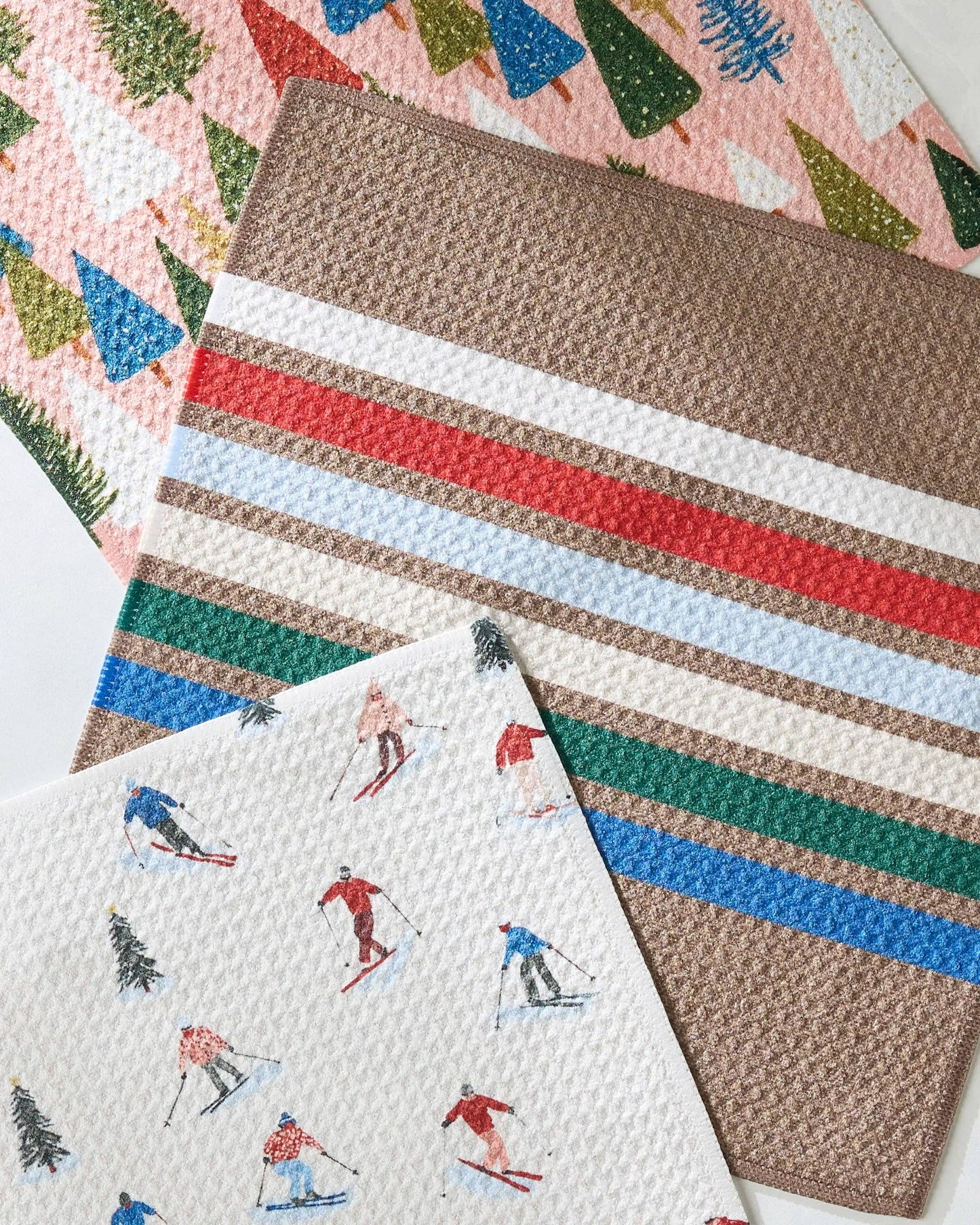 Collection of Geometry dishcloths with different designs including striped and skiing-themed.