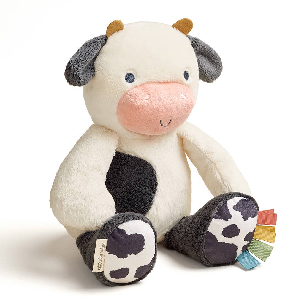 Plush cow toy with a color swatch on a white background