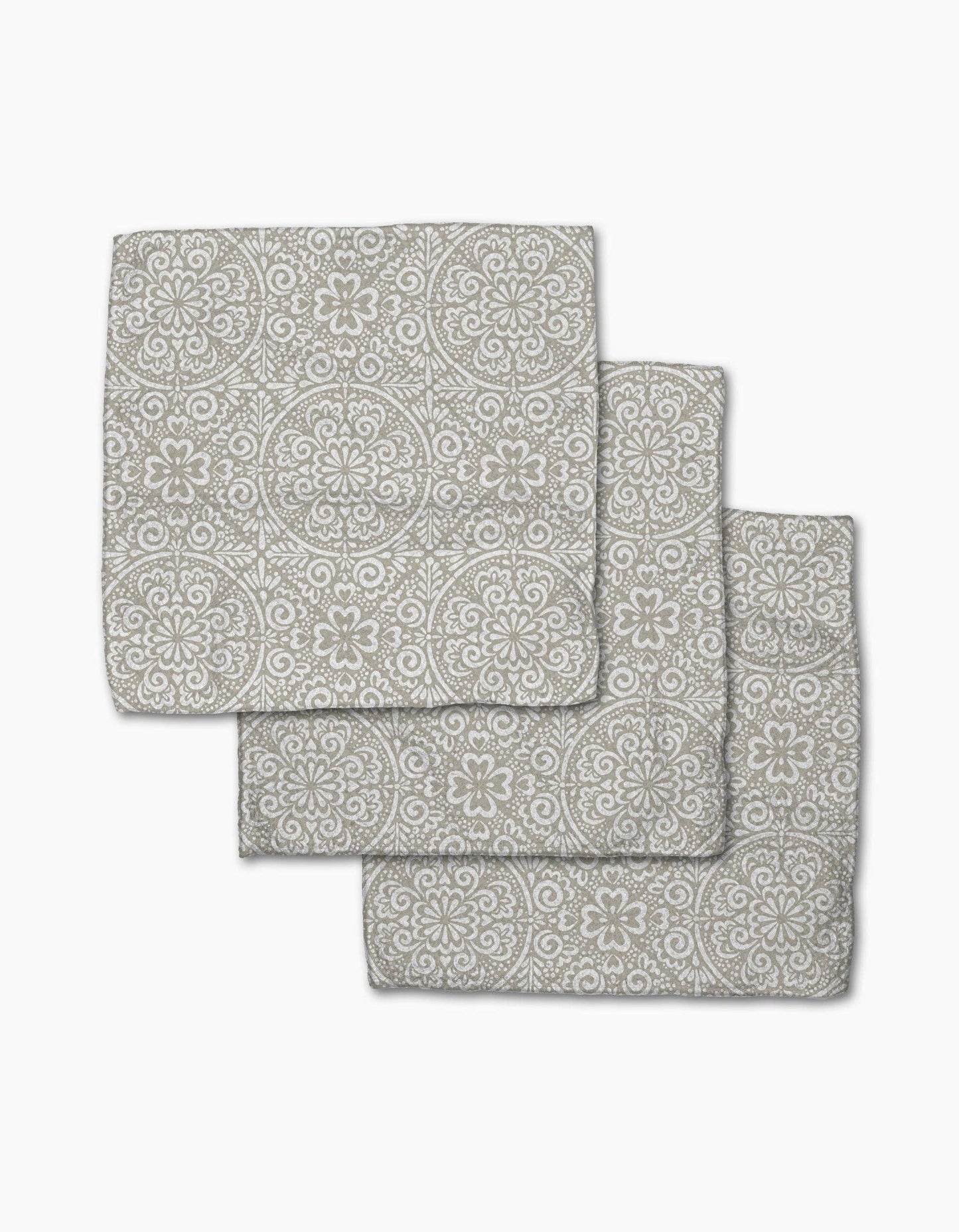 Set of three gray patterned bath mats on a white background