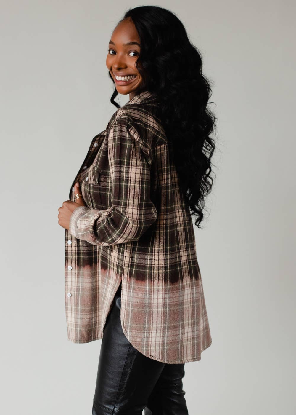 Woman wearing a plaid shirt with a neutral background