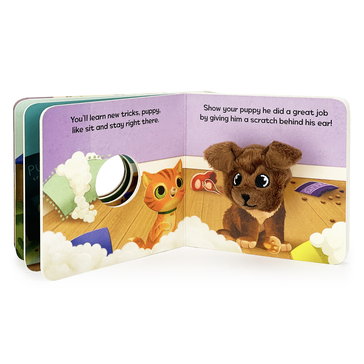 Open children's book with illustrations of a cat and a dog on a wooden floor.