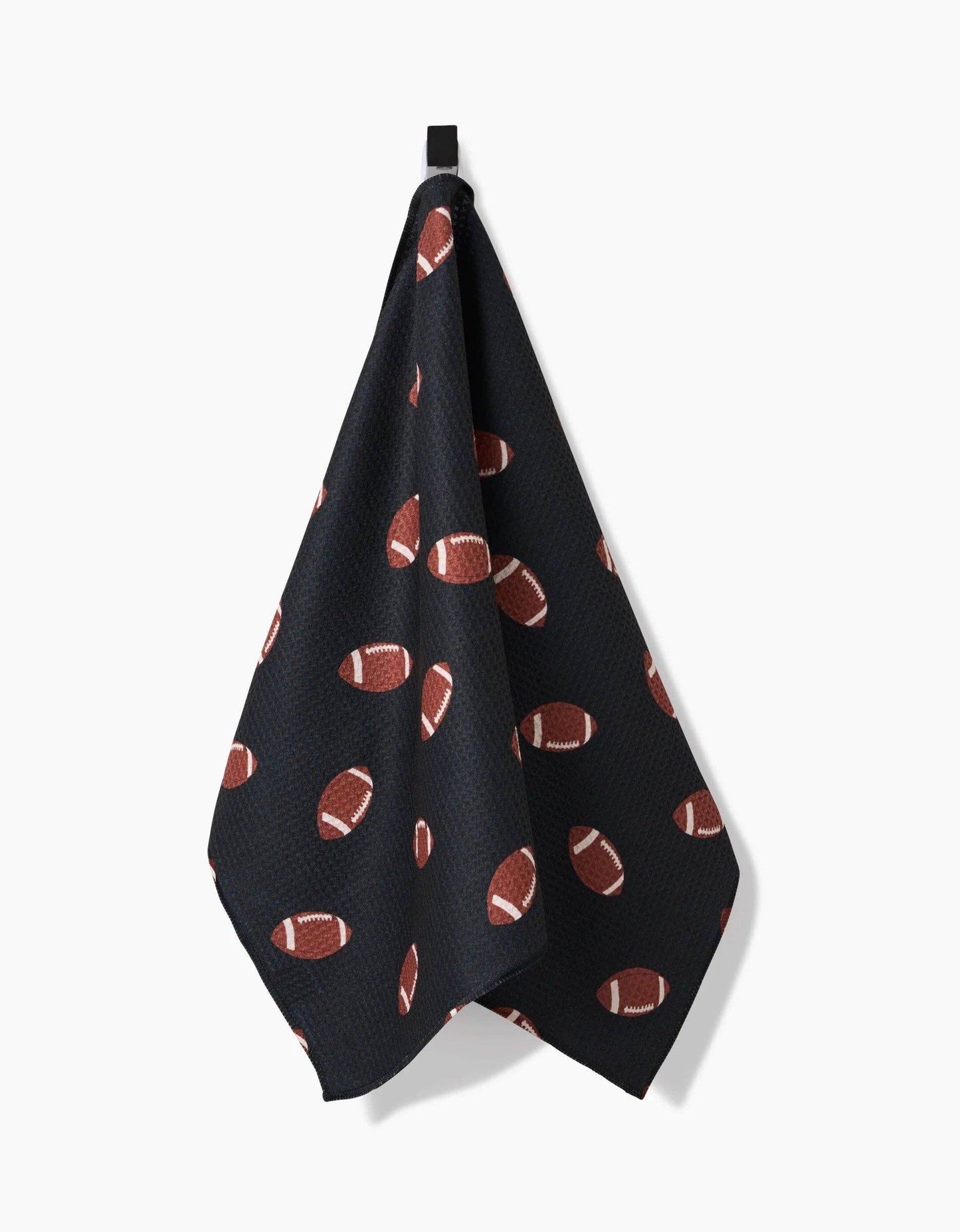 Black Geometry brand kitchen tea towel with brown football pattern on a white background