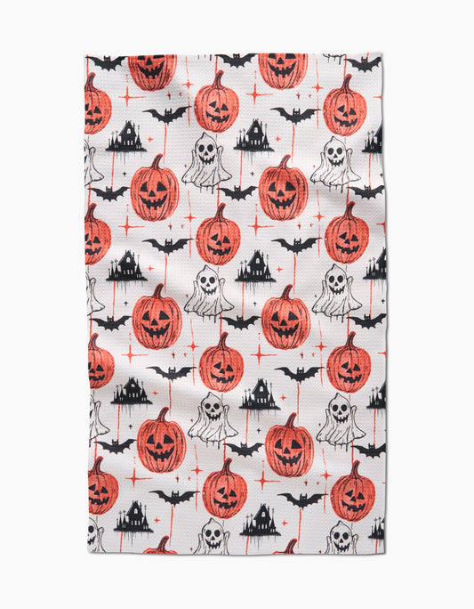 Halloween-themed Geometry tea towel with pumpkins, ghosts, and bats on a white background