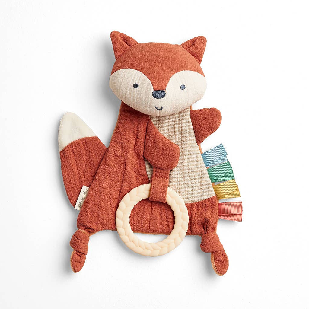 Plush fox toy with a ring on a white background