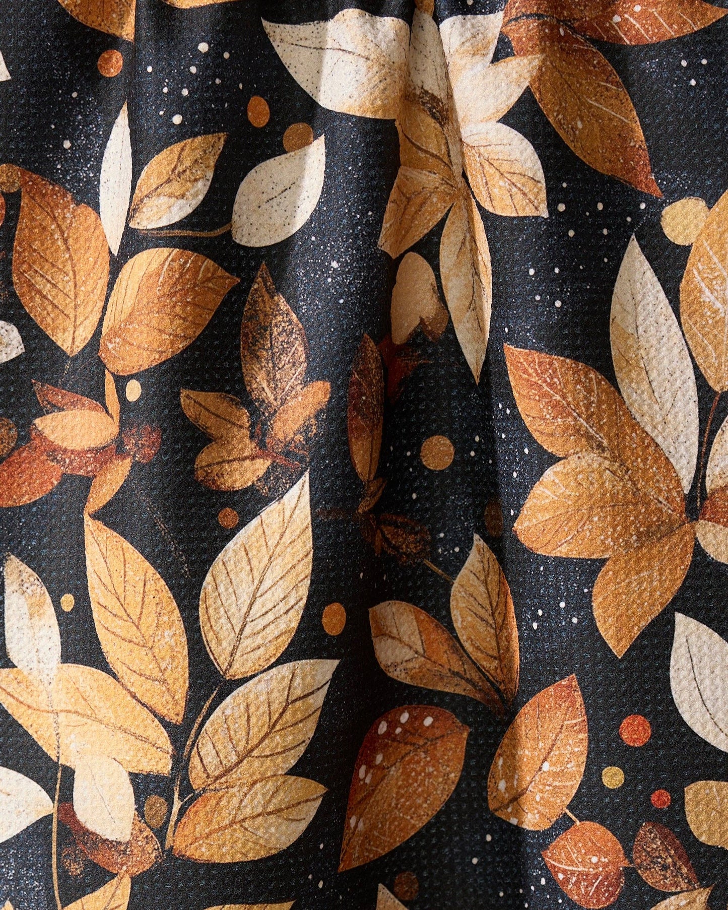 Geometry Kitchen Tea Towel with autumn leaf pattern on a black geoweave background