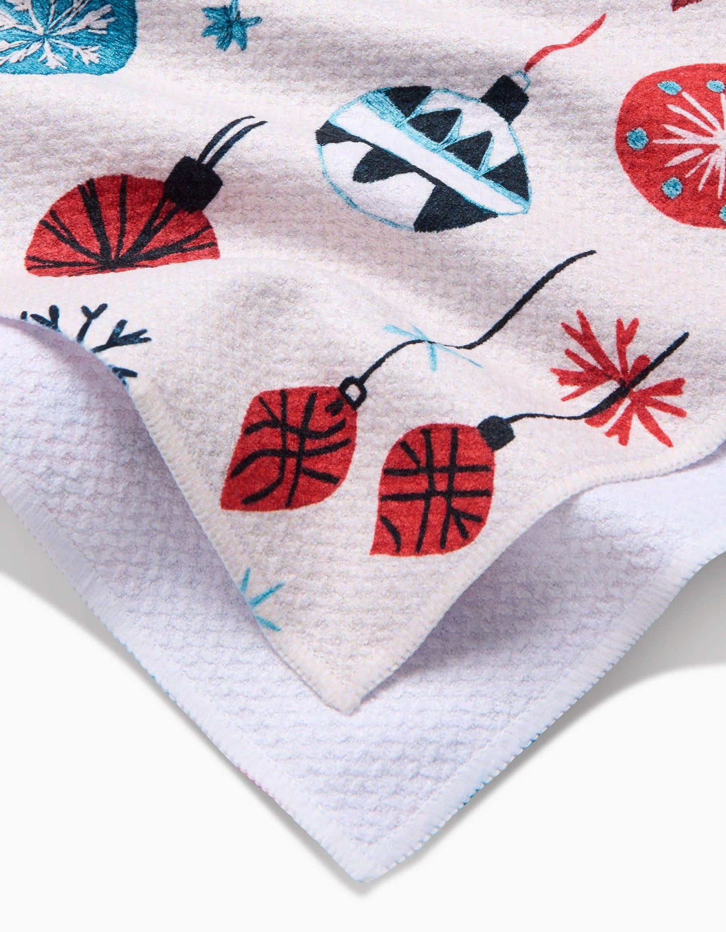 Close-up of a textured fabric with colorful decorative elements on a white background