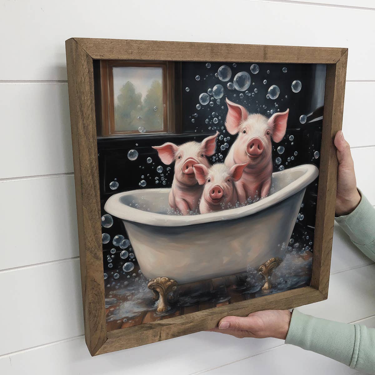 Framed artwork of three pigs in a bathtub with bubbles.