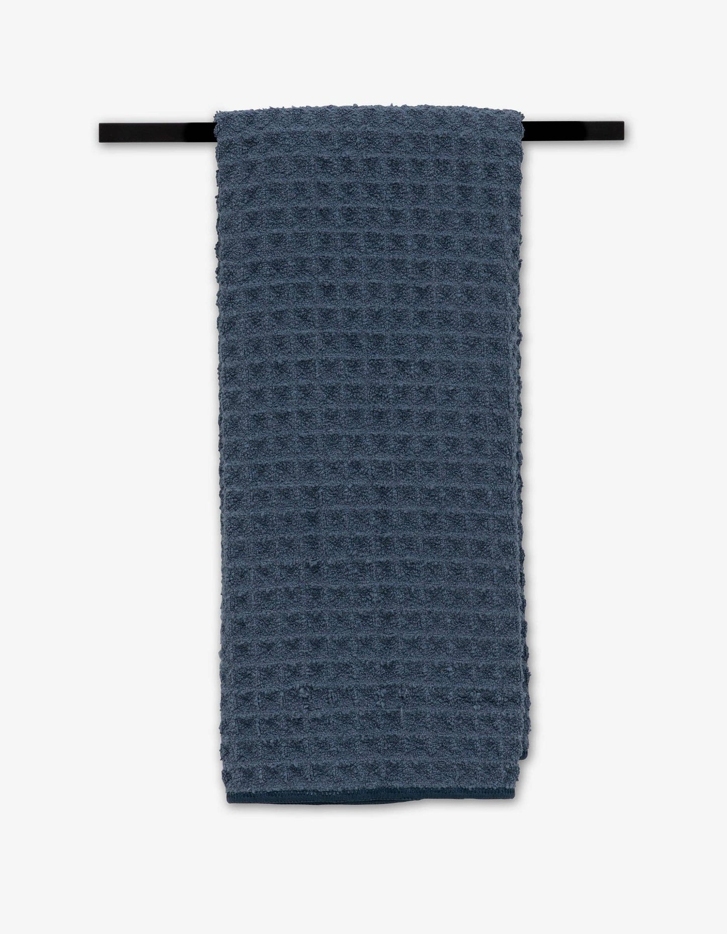 Blue textured towel hanging on a black rod against a white background
