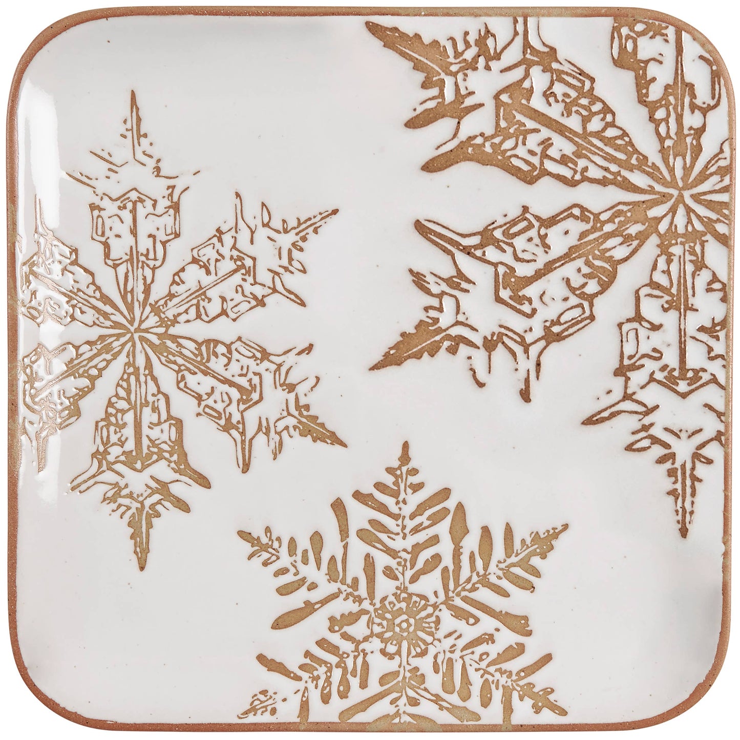 Square ceramic plate with gold snowflake patterns on a white background