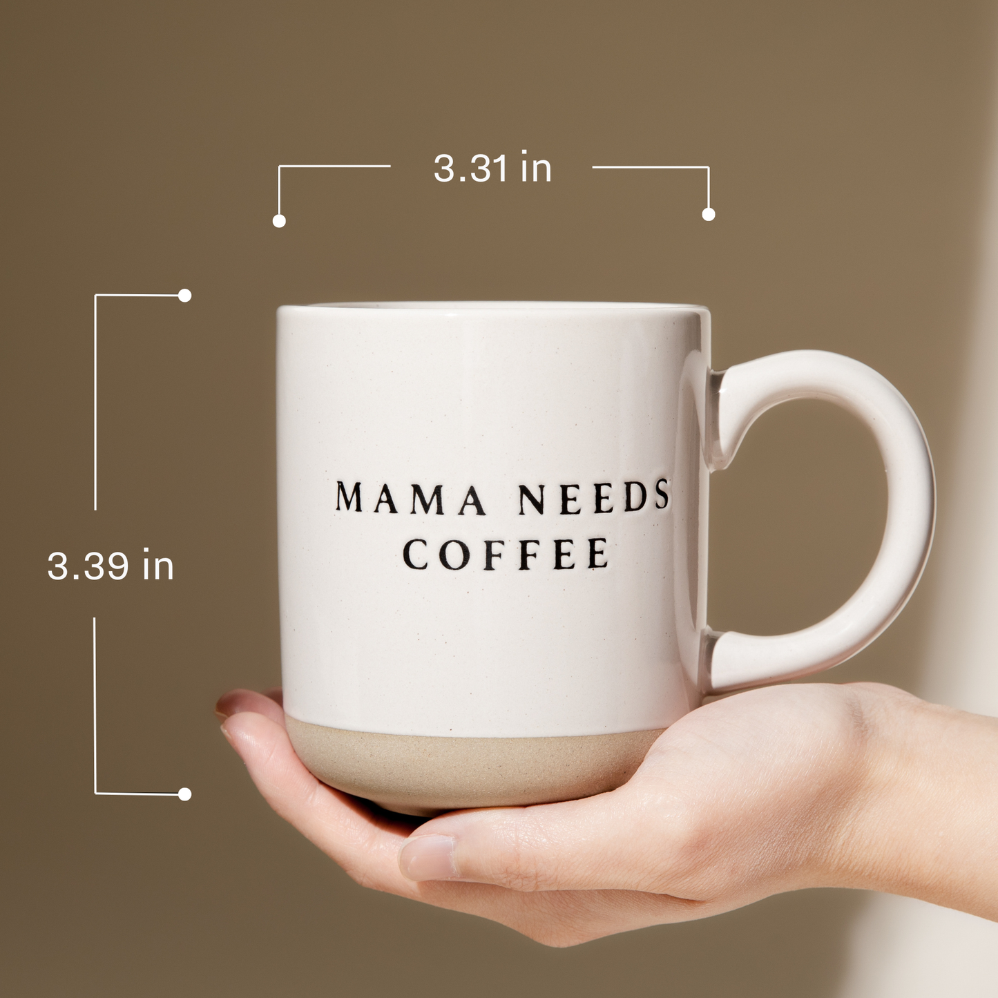White mug with 'MAMA NEEDS COFFEE' text held in a hand against a brown background