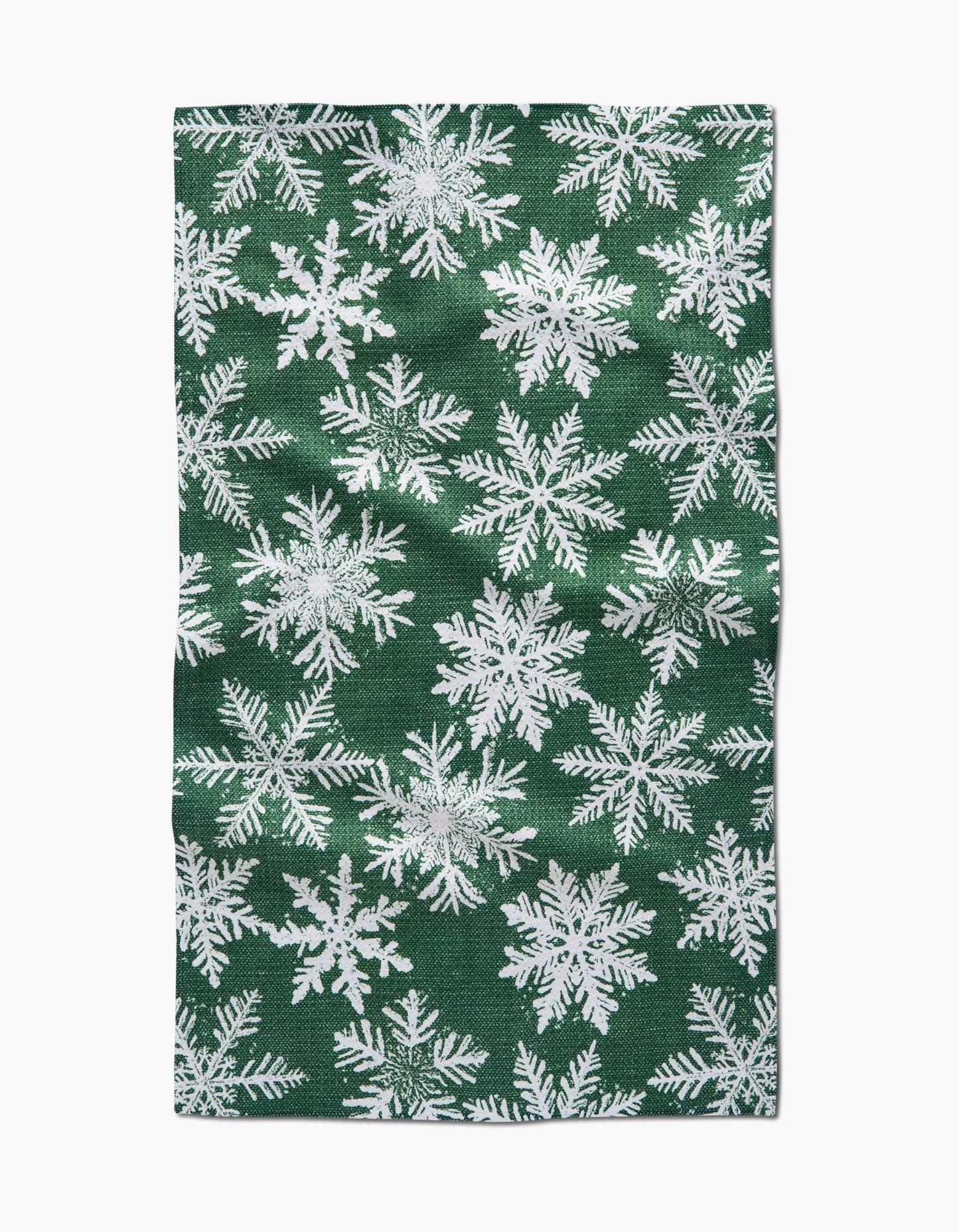 Green fabric with white snowflake pattern