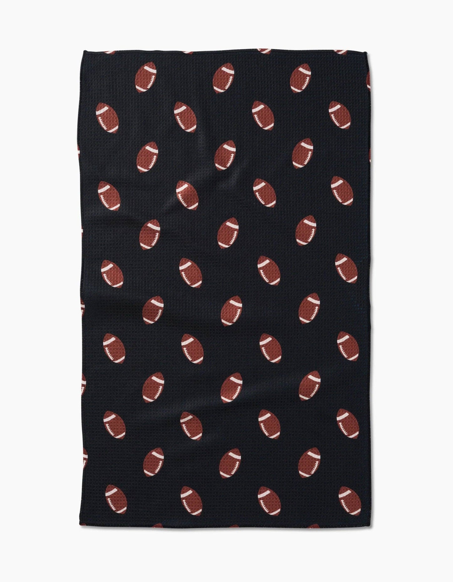 Black Geometry brand kitchen tea towel with brown football pattern on a white background