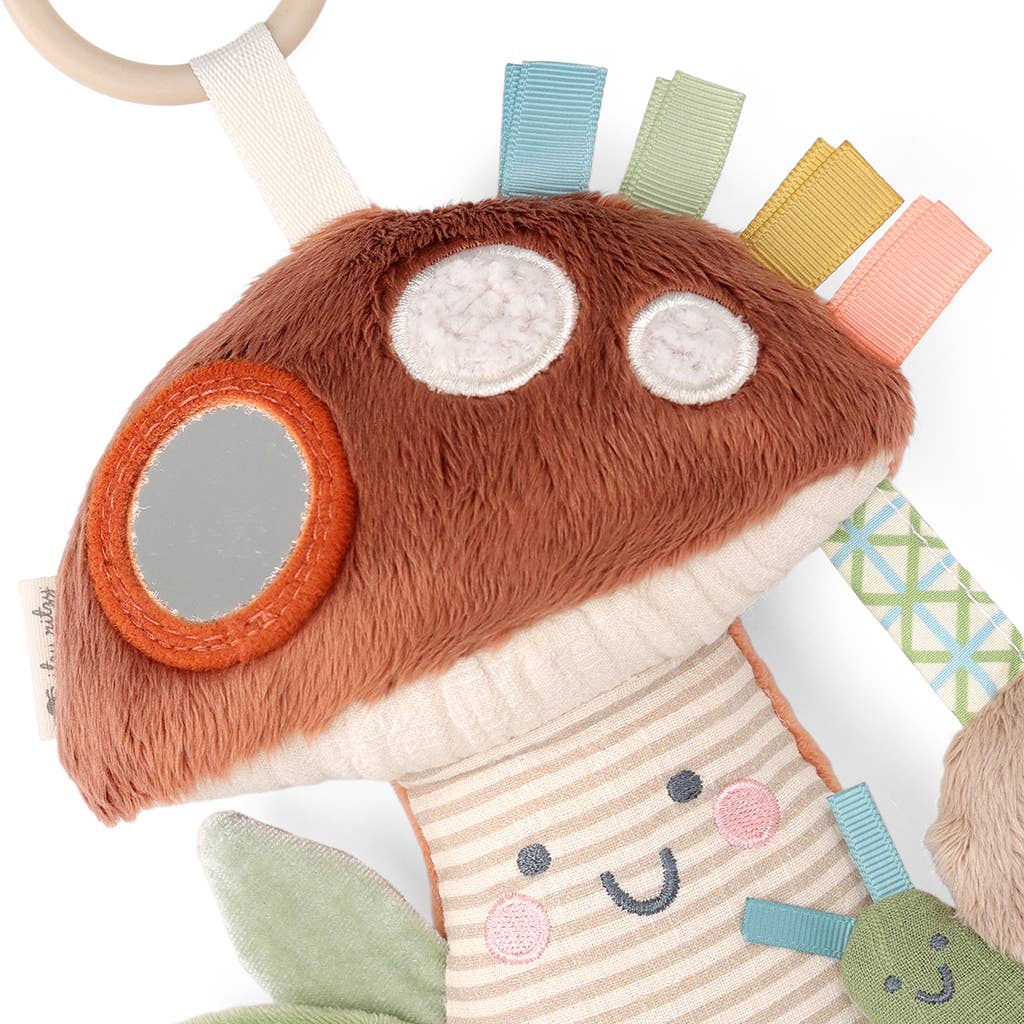 Plush toy with colorful tabs and a mirror on a white background