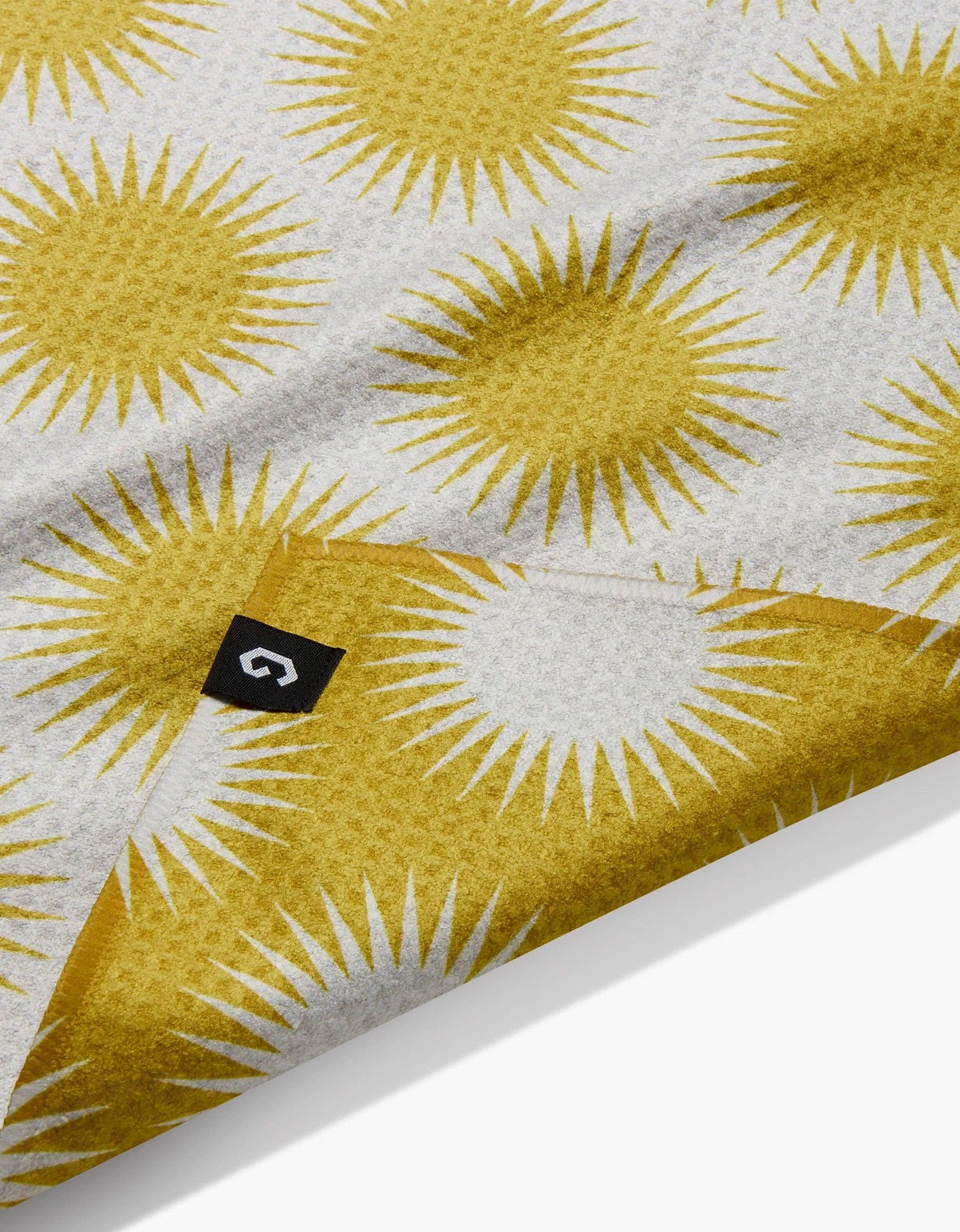Textile with yellow sun pattern on a white background