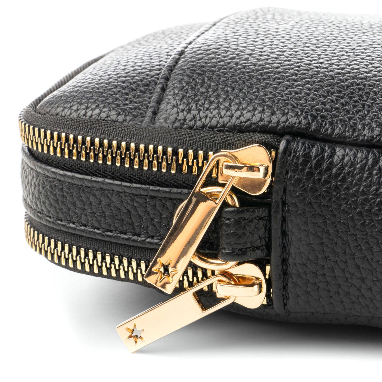 Close-up of a black leather case with a gold zipper.