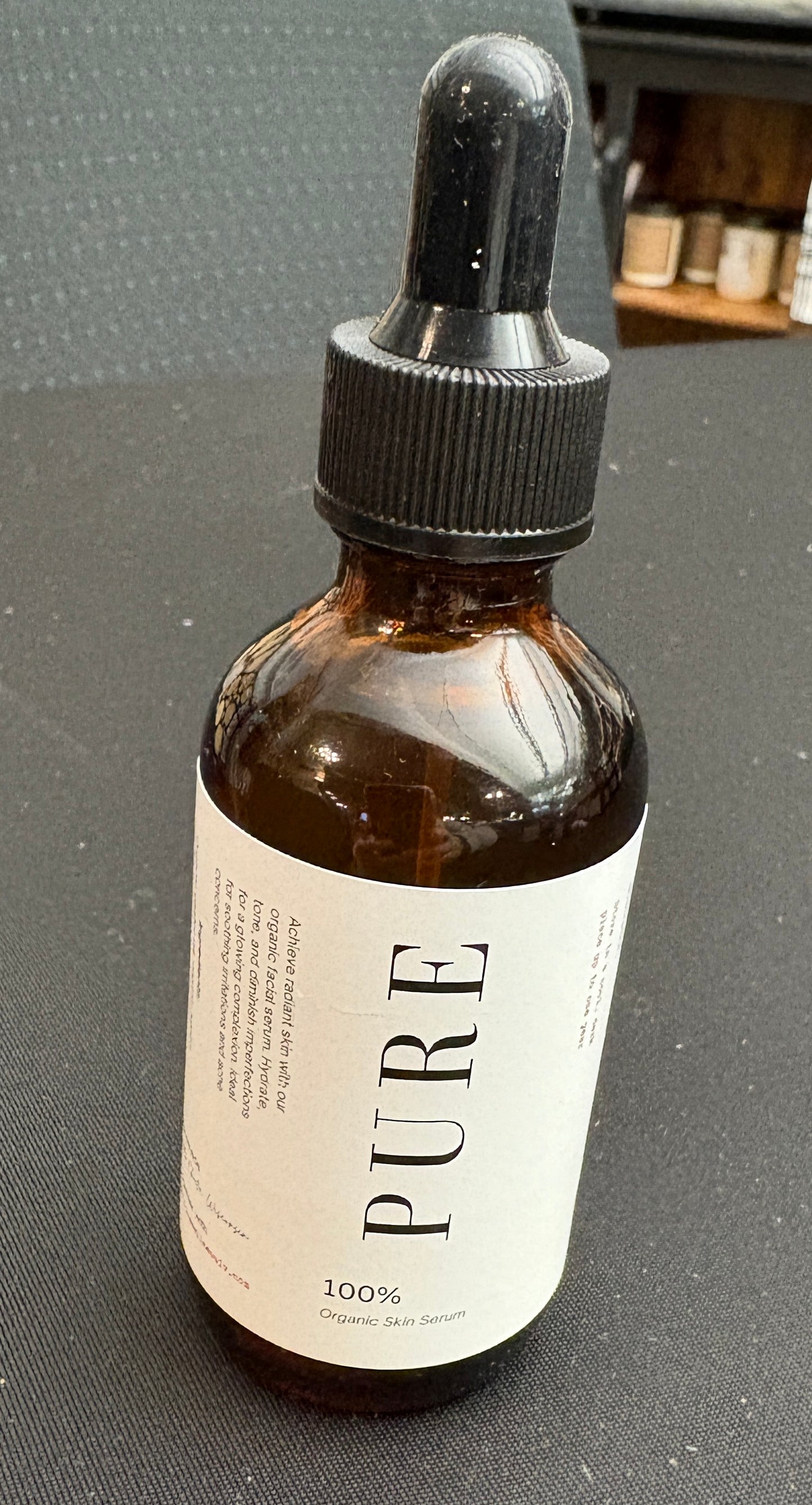 A dropper bottle of Pure Organic Skin Serum with a white label.