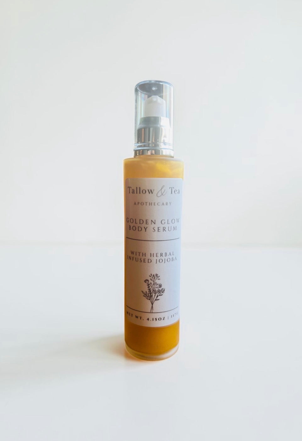 Bottle of Tallow & Tea Apothecary body serum golden glow body serum with herbal infused jojoba on a white background