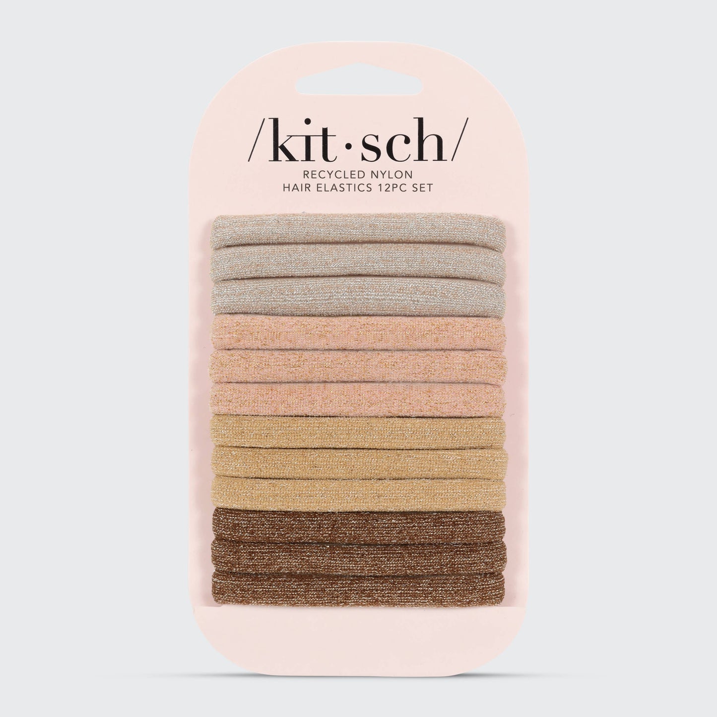 A collection of Kitsch brand glittery nylon hair elastics in various neutral shades, displayed both in a stack and in packaging.