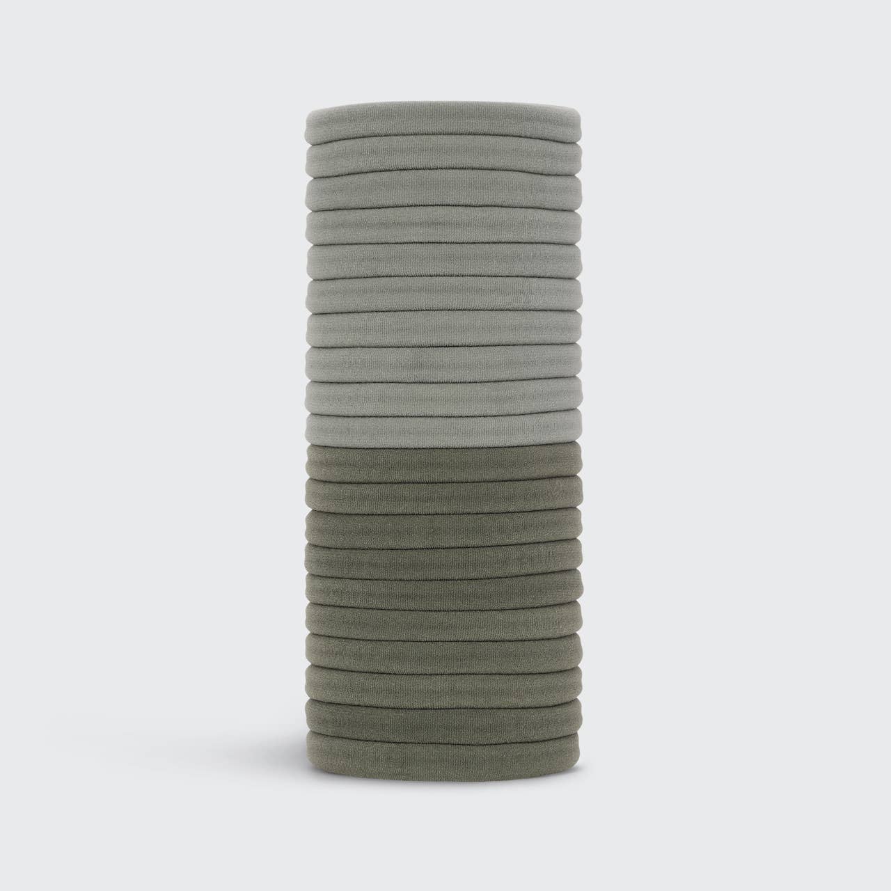 Stack of gray hair ties on a white background