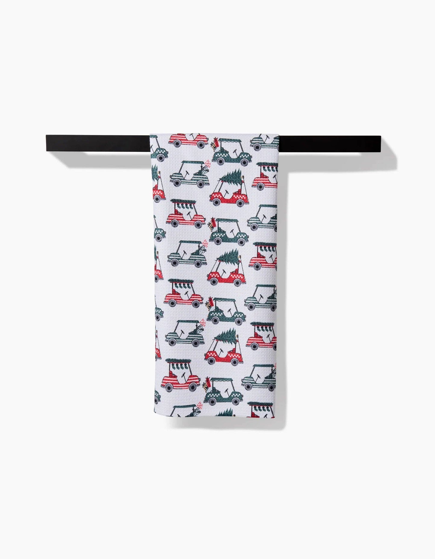 Geometry Tea Towel with Christmas-themed vehicle pattern hanging on a black rack against a white background