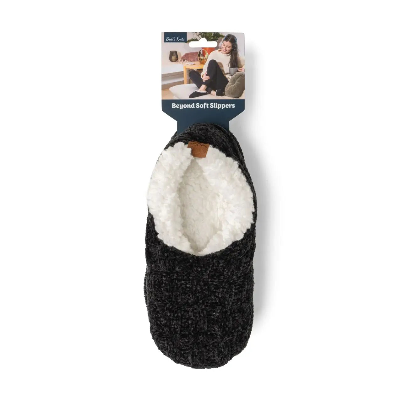 Black slipper with white interior on a white background, featuring a 'Beyond Soft Slippers' tag.