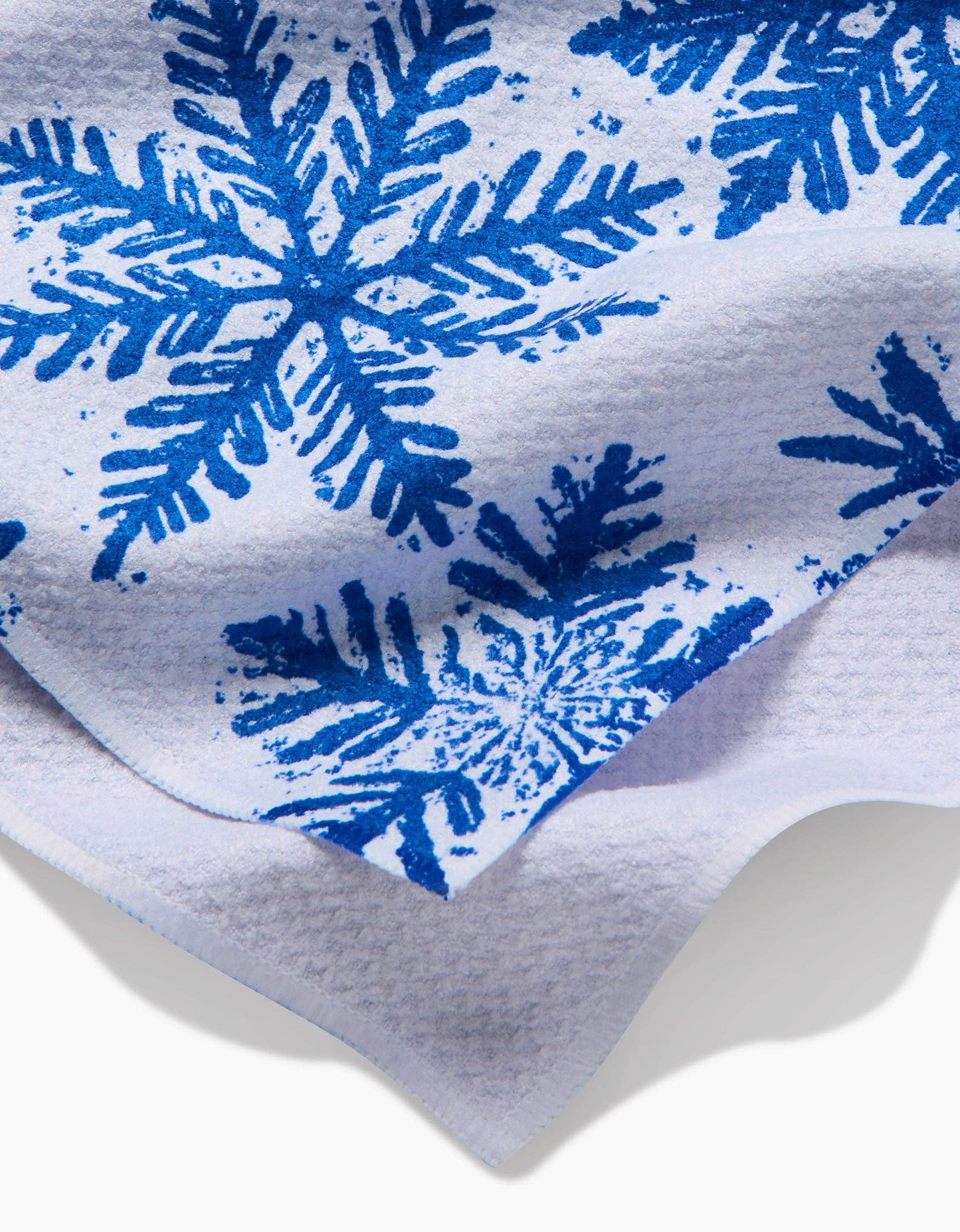 Close-up of a white fabric with blue snowflake patterns