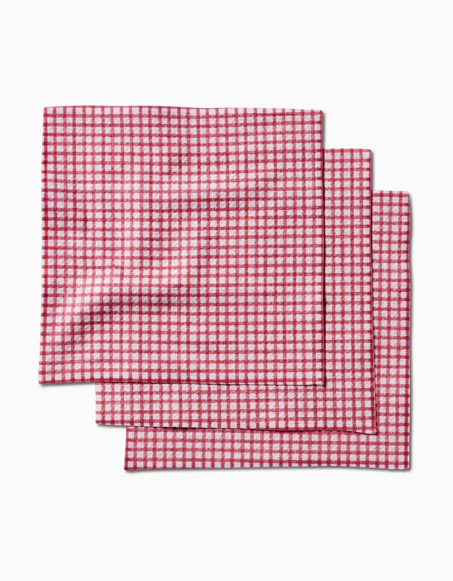 Three red and white checkered placemats on a white background