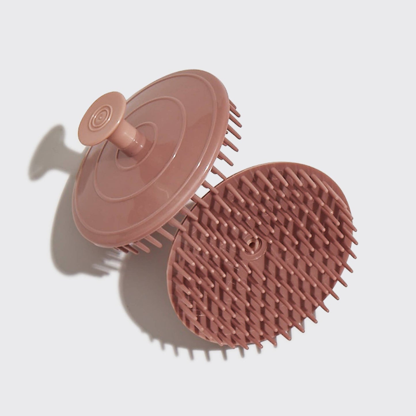 Pink silicone scrubber on a light gray background