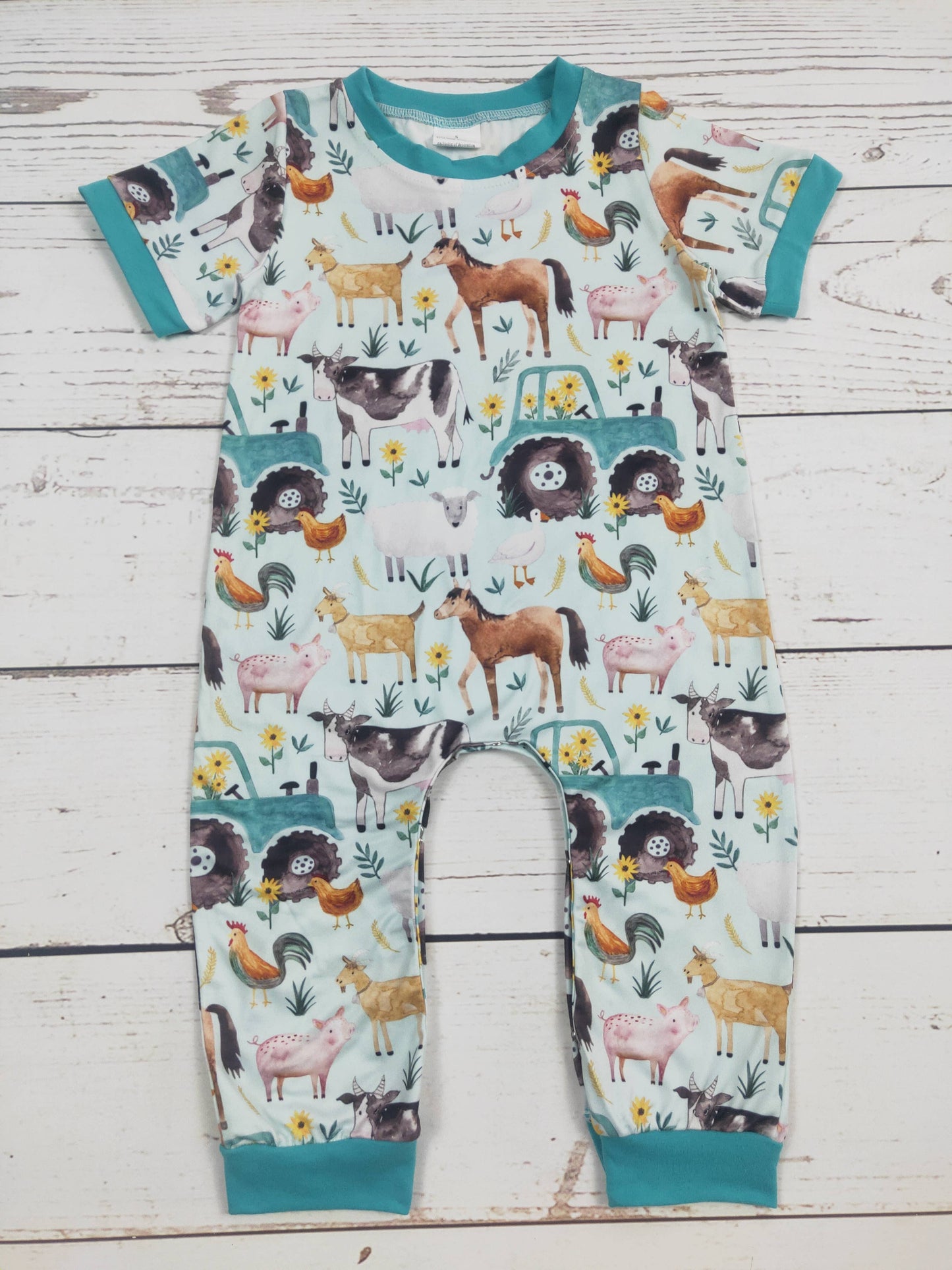 Children's onesie with animal pattern on a wooden surface