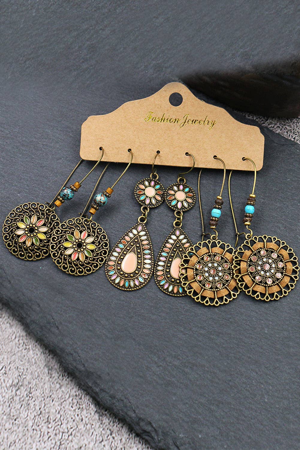 Set of ornate earrings on a 'Fashion Jewelry' card against a dark background