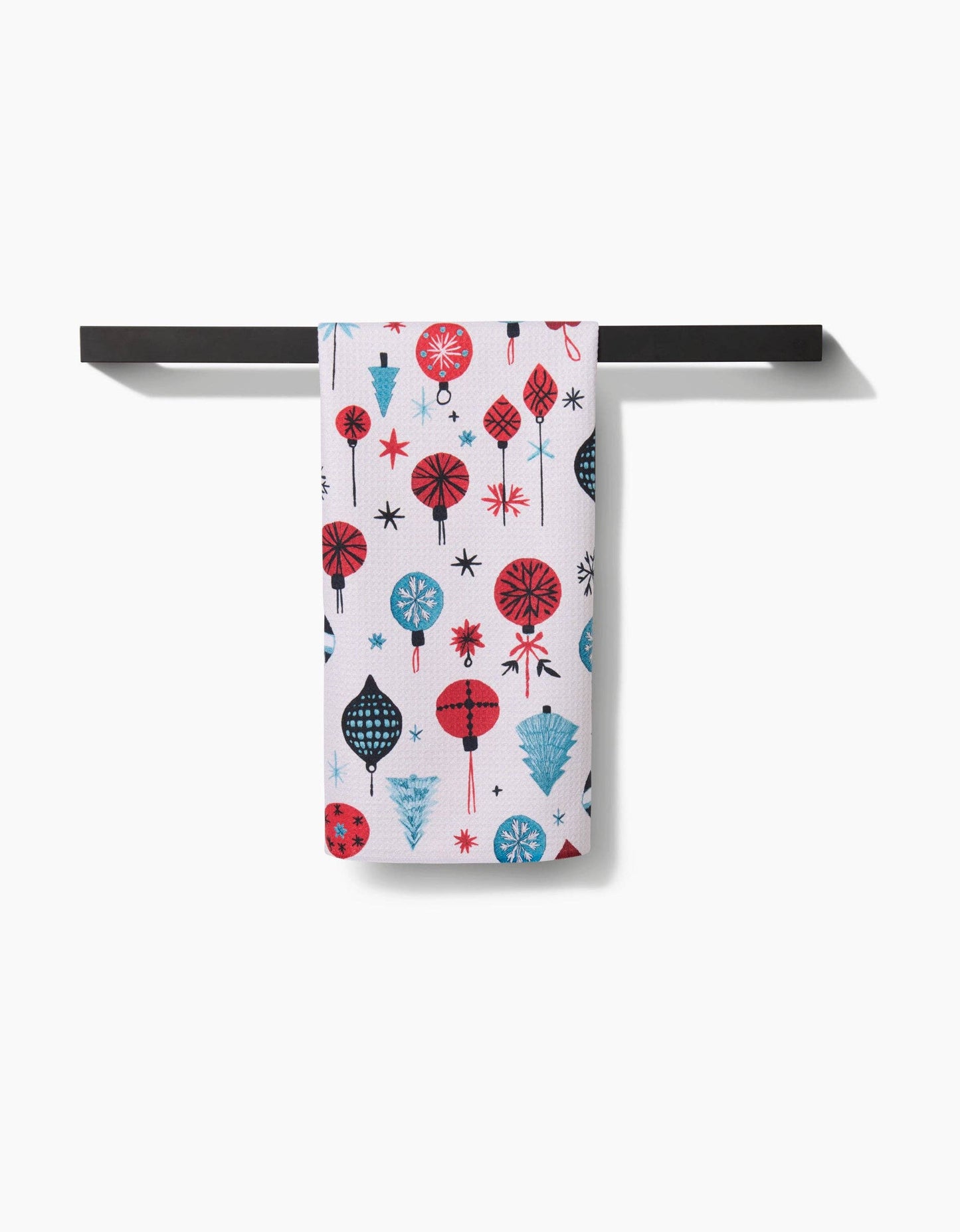 Towel with colorful abstract pattern hanging on a black rod against a white background