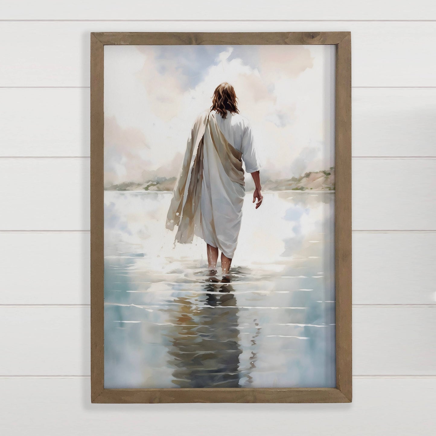 Framed artwork of a person walking on water with a wooden frame.