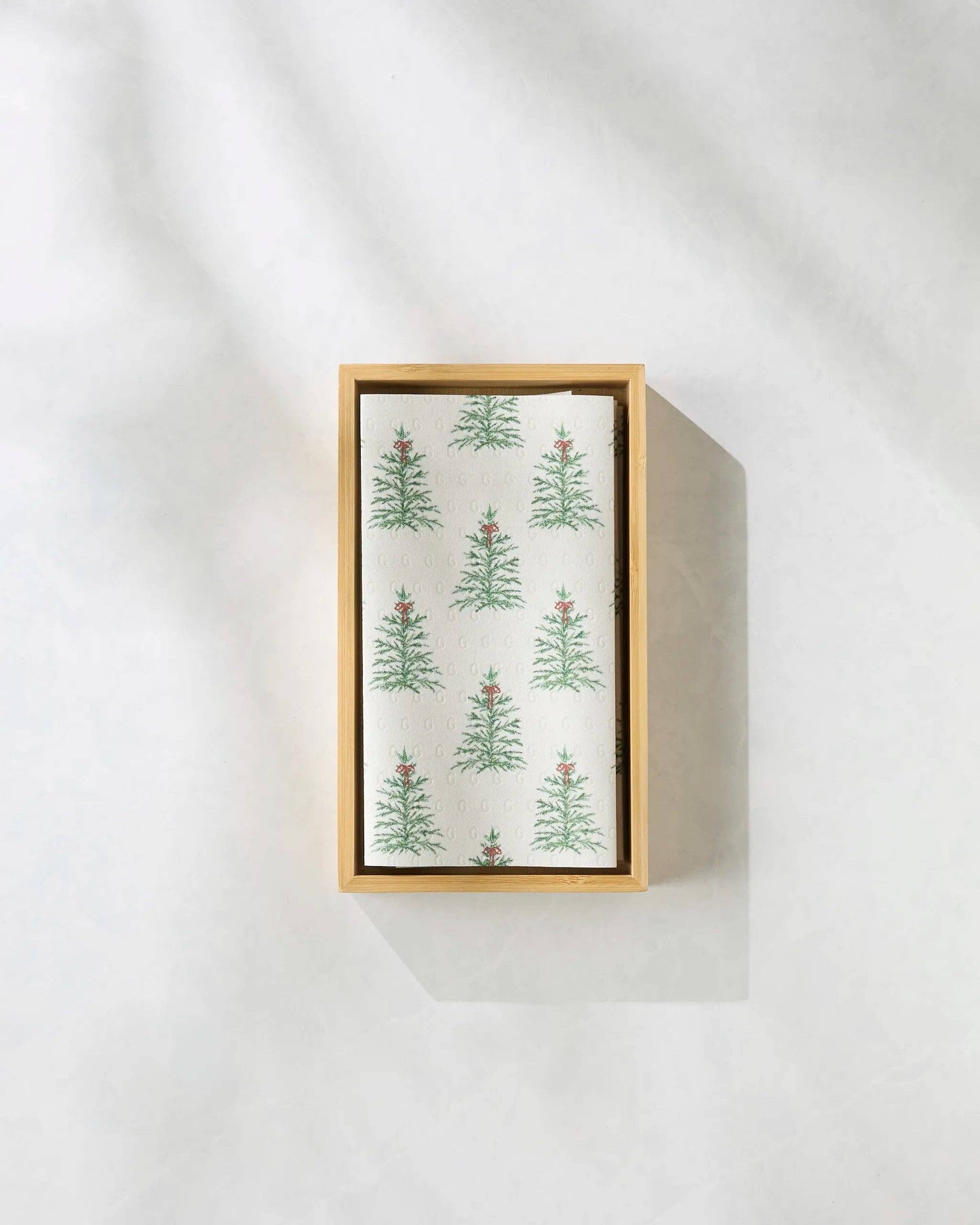 Box of tea towels with Christmas tree pattern on a white background