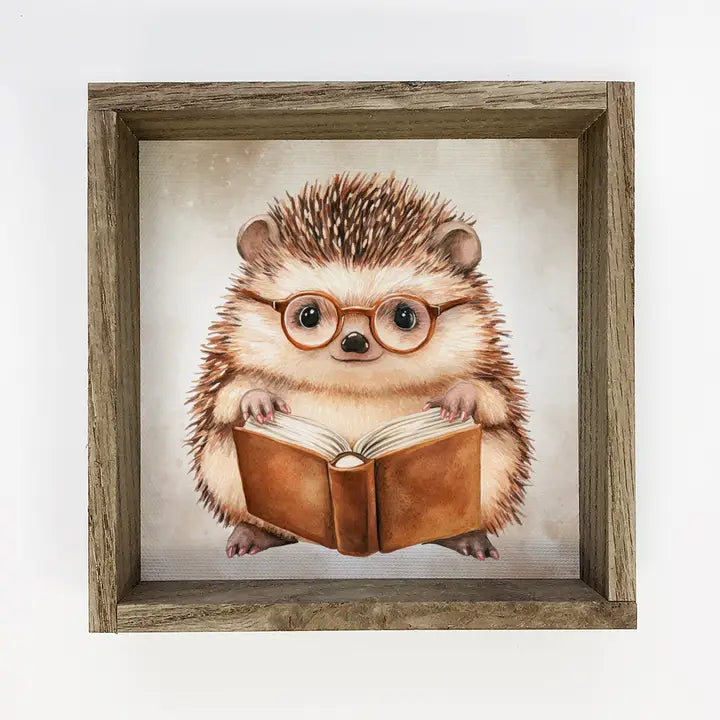 Framed artwork of a hedgehog wearing glasses and holding a book