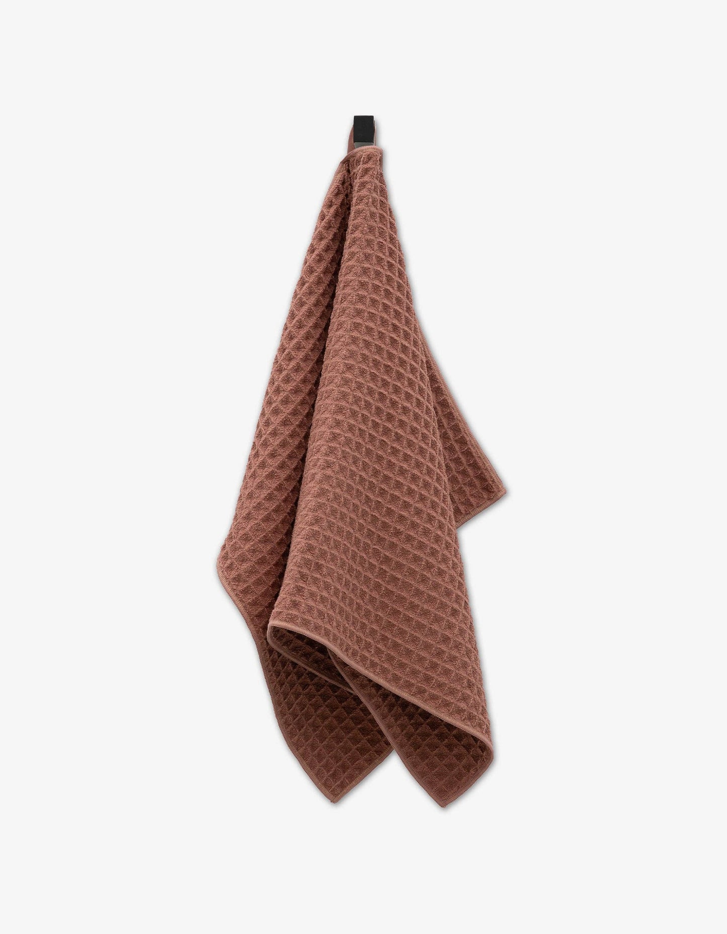 Geometry waffle-textured towel hanging on a white background