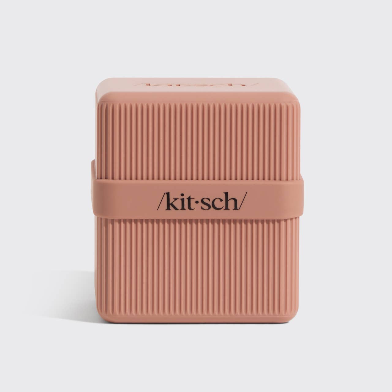 Pink rectangular travel case with 'kitsch' branding on a light gray background