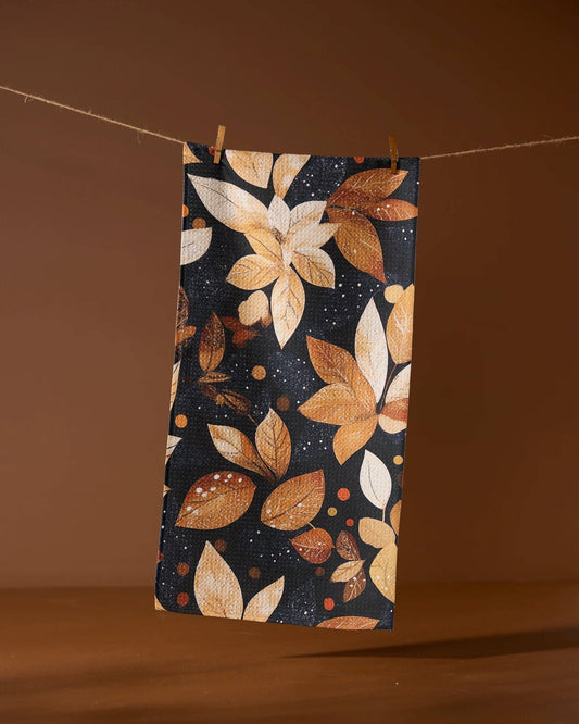 Geometry bar towel with autumn leaf pattern hanging on a line against a brown background