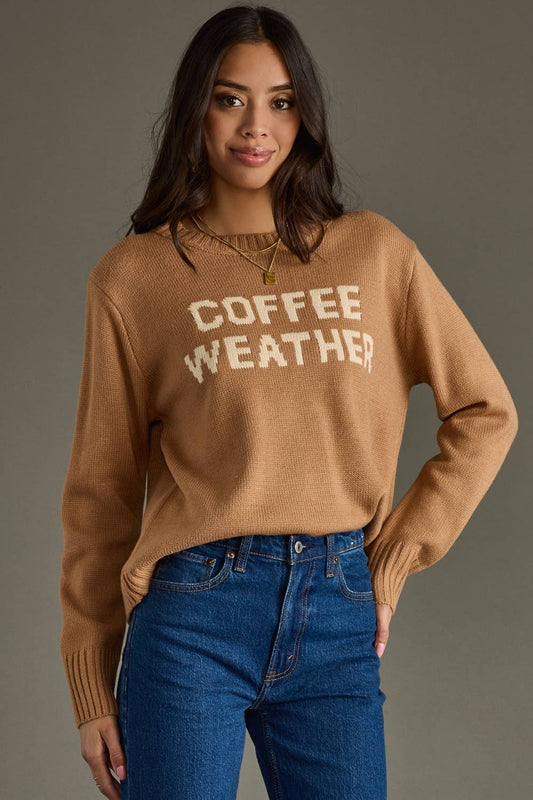 Woman wearing a brown sweater with 'COFFEE WEATHER' text against a gray background