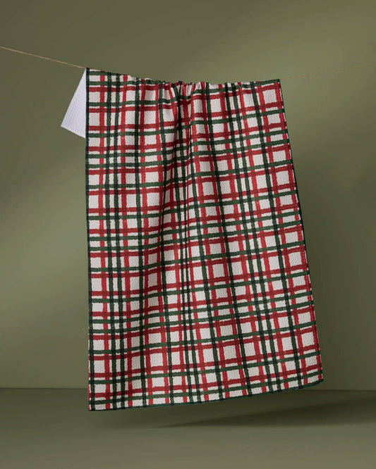 Geometry Tea Towel Plaid towel hanging on a line against a green background