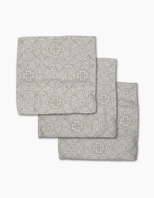Set of three gray patterned bath mats on a white background