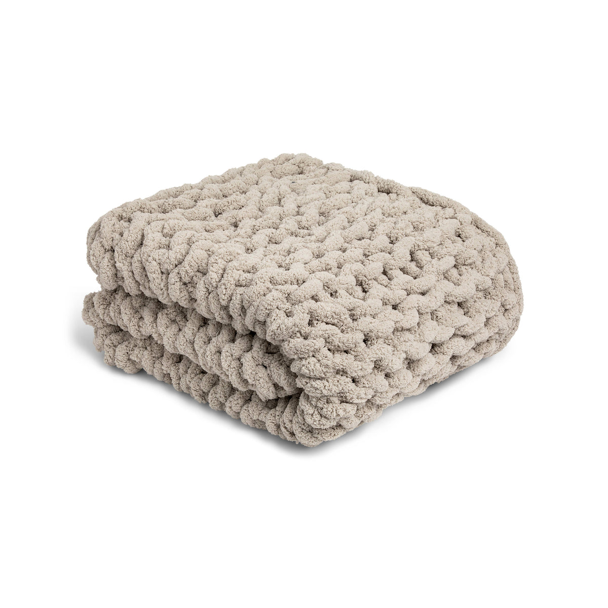 Folded chunky knit throw  blanket on a white background