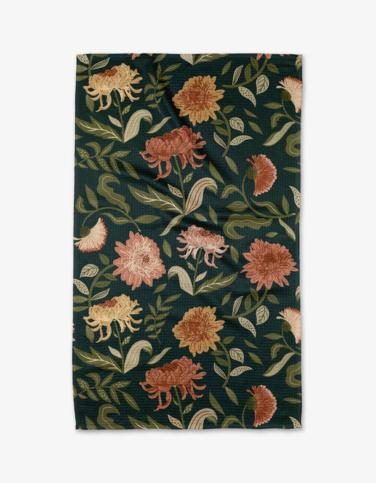 Geometry tea towel with a floral pattern, featuring colors such as green and shades of brown.