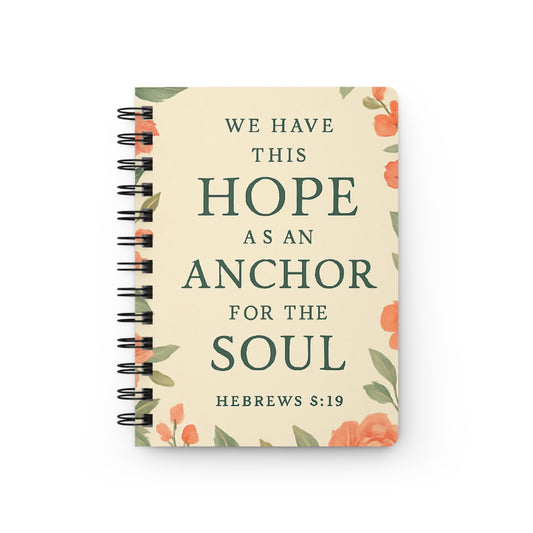 Notebook with floral design and inspirational quote on a white background