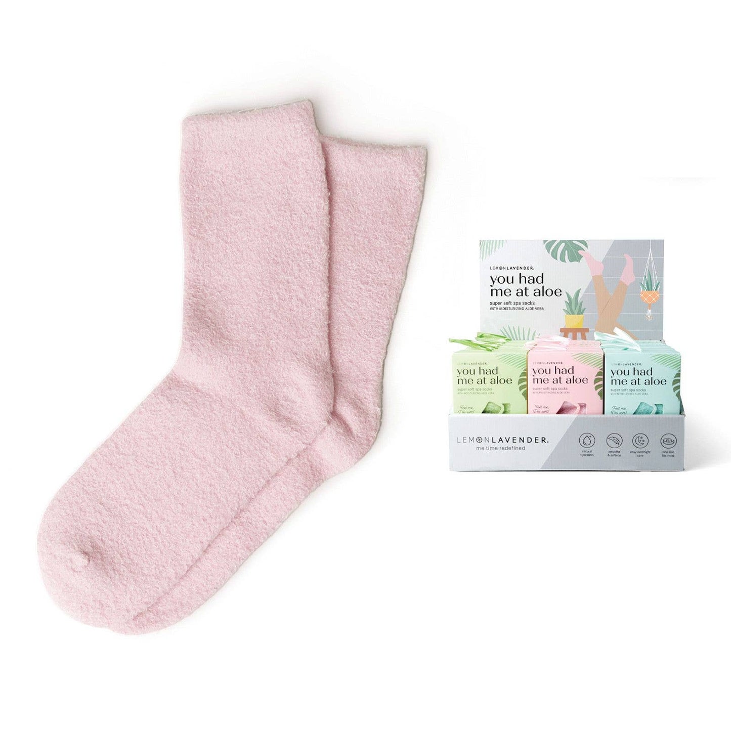 A pair of pink spa socks displayed alongside a color assortment pack with blue and green socks, labeled 'You Had Me At Aloe'.