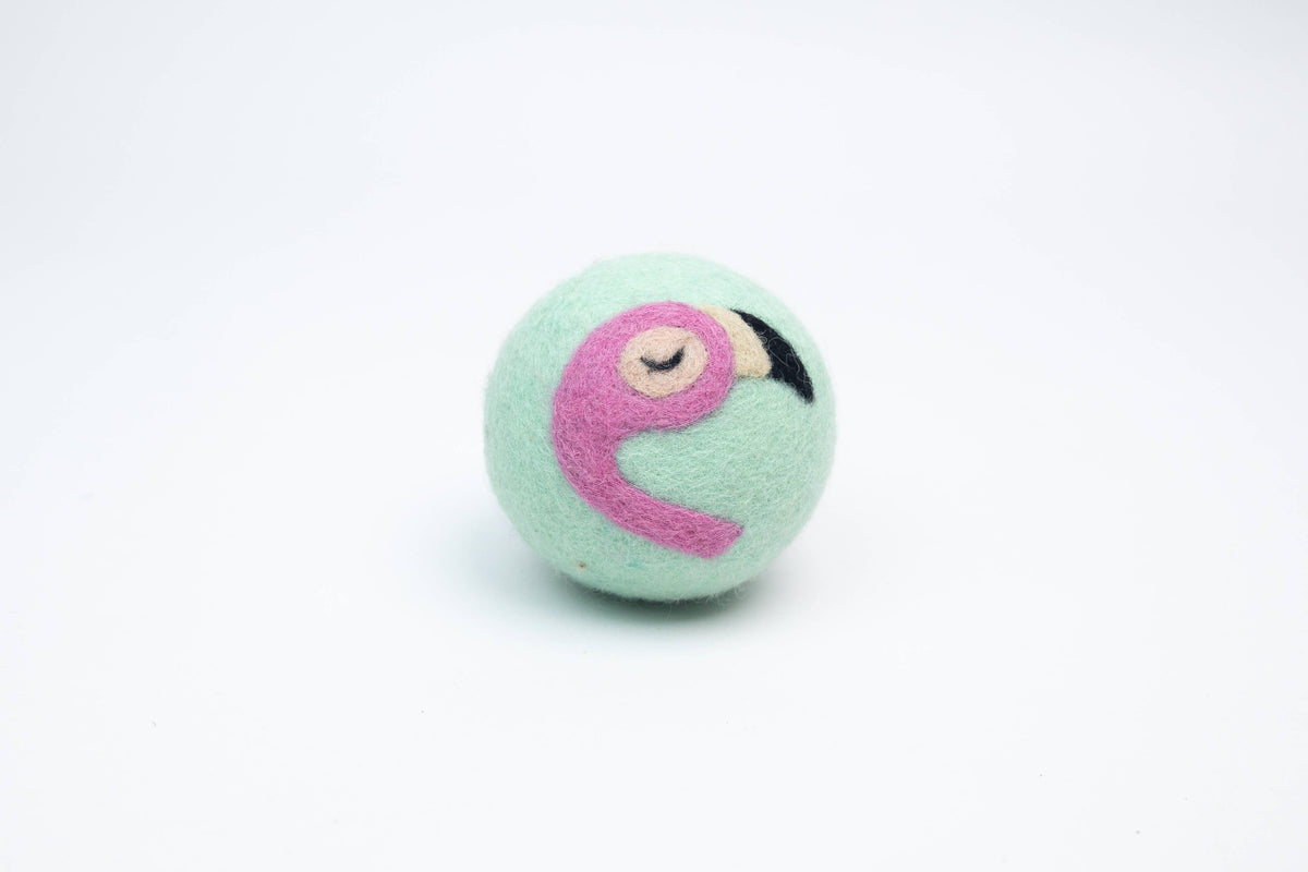 Light blue wool dryer ball with a pink flamingo design on a white background