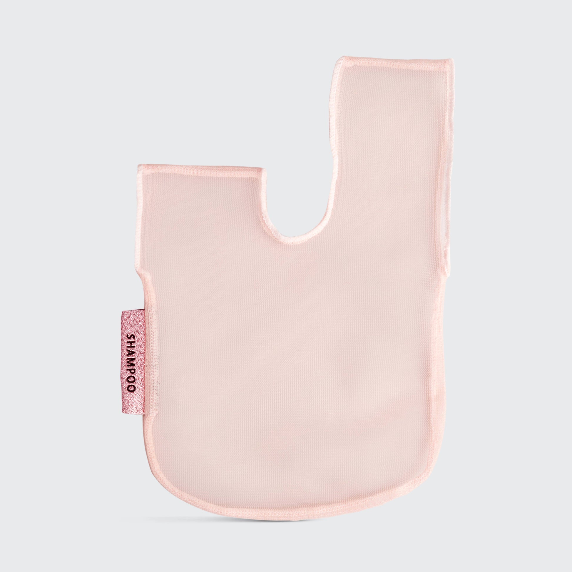 A blush pink mesh fabric shampoo beauty bar bag with a transparent window displaying the product. It is packaged with a product card that has text including the brand name and product description.