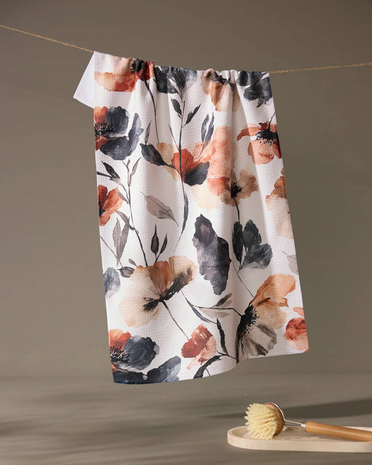 Geometry brand kitchen tea towel with floral patterned towel hanging on a line with a neutral background