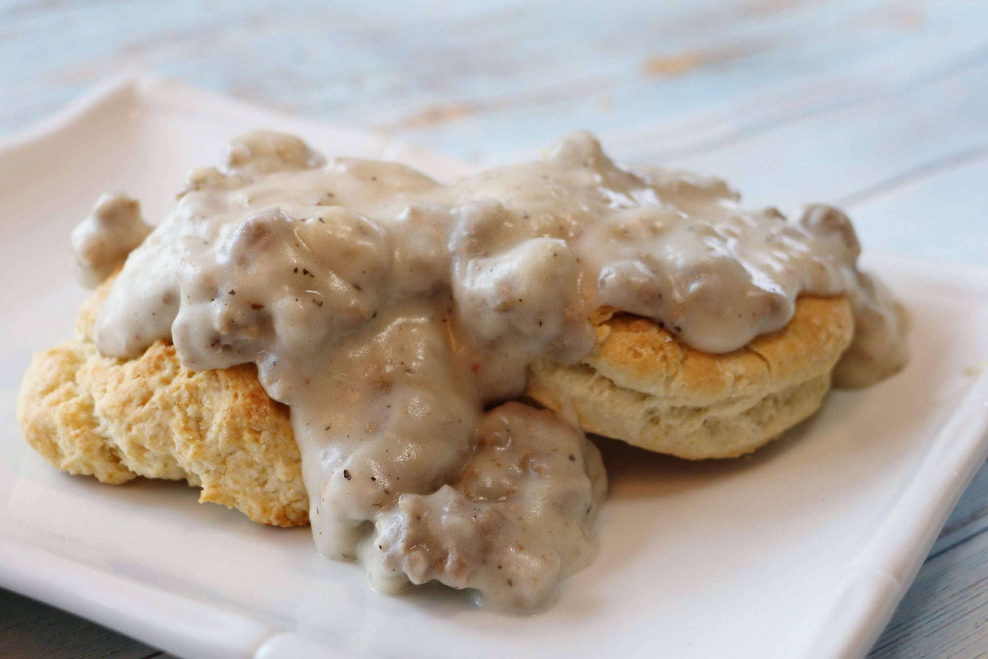 Biscuits with gravy on a white plate