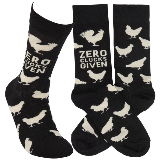 Black socks with white chicken illustrations and text 'Zero Clucks Given' on a white background