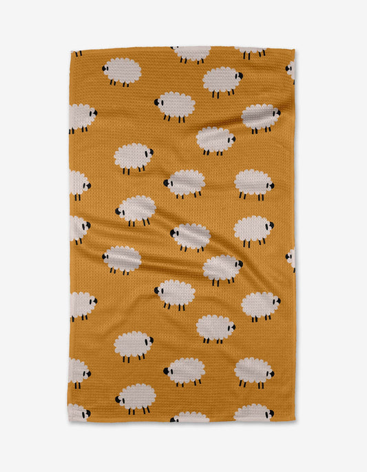 Fabric with sheep pattern on a mustard yellow background